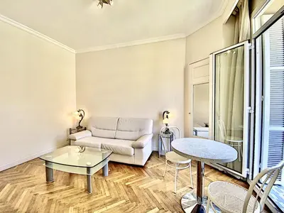 a living room with a couch and a table at Palais Hoche 2P LON5218 in Cannes