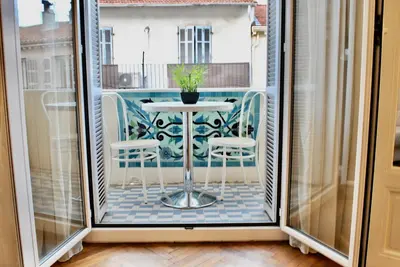 a small balcony with a table and chairs at Palais Hoche 2P LON5218 in Cannes