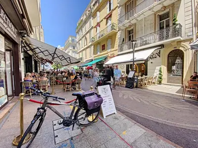 a bike parked on a sidewalk in a city at Palais Hoche 2P LON5218 in Cannes