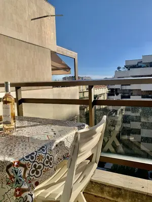 a table and a chair on a balcony at Gray d'Albion POL519 studio in Cannes