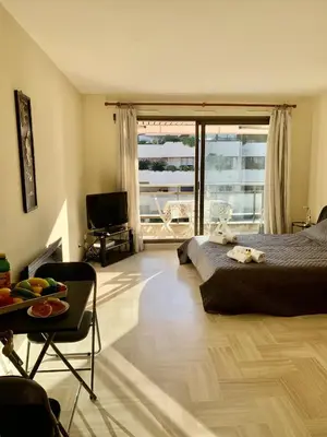 a bedroom with a bed and a large window at Gray d'Albion POL519 studio in Cannes