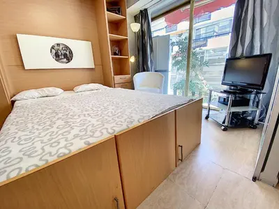 a small bedroom with a bed and a tv at Imperial Croisette FER3417 studio in Cannes