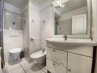 a bathroom with a sink and a toilet and a mirror at Imperial Croisette FER3417 studio in Cannes