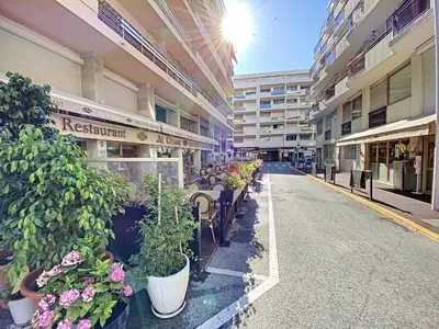 an empty street with potted plants in a building at Imperial Croisette FER3417 studio in Cannes
