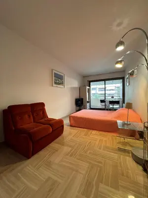 a bedroom with a bed and a couch and a table at Gray d'Albion VIM1163 studio in Cannes