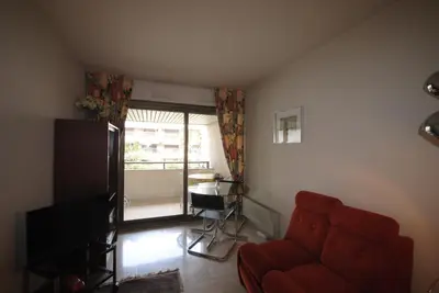 a living room with a red couch and a table at Gray d'Albion VIM1163 studio in Cannes