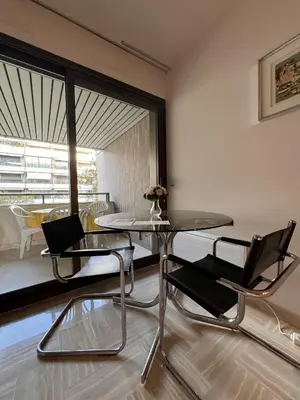 a dining room with a glass table and chairs at Gray d'Albion VIM1163 studio in Cannes