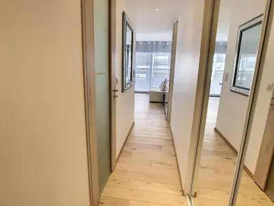 a hallway of an office building with a mirror at Grand studio cabine à côté des plages NER634 in Cannes