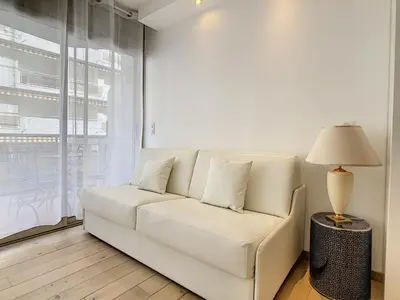 a white couch in a living room with a lamp at Grand studio cabine à côté des plages NER634 in Cannes