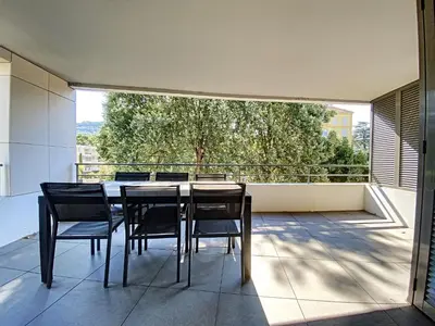 a dining room with a table and chairs on a balcony at Montfleurie TEI142 3P in Cannes