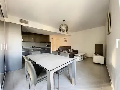 a kitchen and living room with a table and chairs at Montfleurie TEI142 3P in Cannes