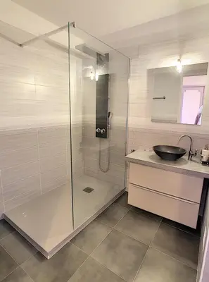 a bathroom with a glass shower and a sink at Le Windsor 2P DET2002 in Cannes