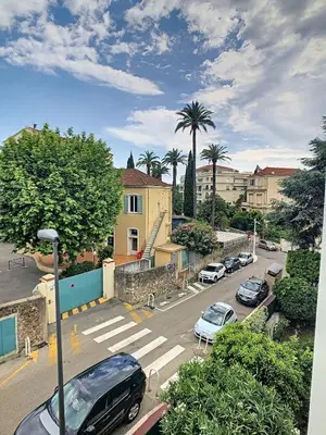 a parking lot with cars parked in a city at Le Windsor 2P DET2002 in Cannes