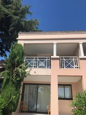 a pink house with two chairs in front of it at T2 superbe vue mer Cannes in Cannes