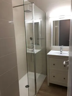 a bathroom with a glass shower and a sink at T2 superbe vue mer Cannes in Cannes