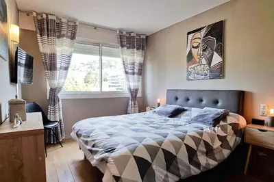 a bedroom with a large bed and a window at 4-Room Apartment with Terrace & Sea View 5-Minute Walk to the Beach in Cannes