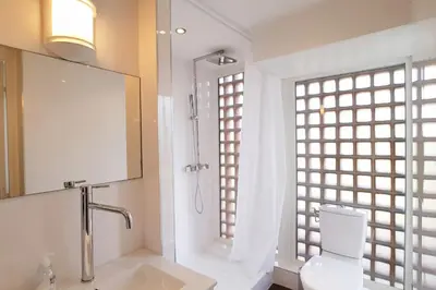 a bathroom with a sink and a toilet and a mirror at 4-Room Apartment with Terrace & Sea View 5-Minute Walk to the Beach in Cannes