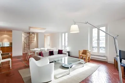 a living room with a white couch and a table at REF 35 - Cannes Center - Duplex apartment for rent in Cannes