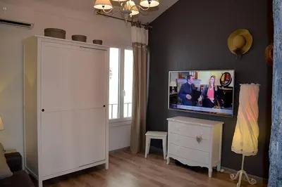 a living room with a tv on a wall at Cannes croisette in Cannes