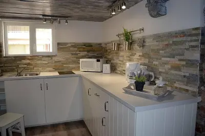 a kitchen with white cabinets and a counter top at Cannes croisette in Cannes