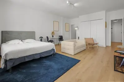 a bedroom with a bed and a living room at Magnifique appartement - 15 minutes a pieds PALAIS in Cannes
