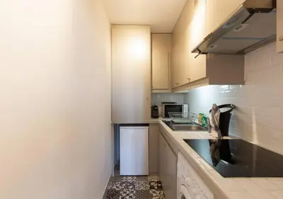 a small kitchen with a sink and a microwave at Magnifique appartement - 15 minutes a pieds PALAIS in Cannes