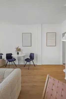 a living room with a table and two chairs at Magnifique appartement - 15 minutes a pieds PALAIS in Cannes