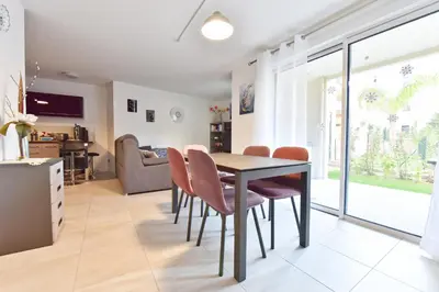 a dining room with a table and chairs at 2-Br with Terrace and Pool in the Heart of Palm Beach in Cannes