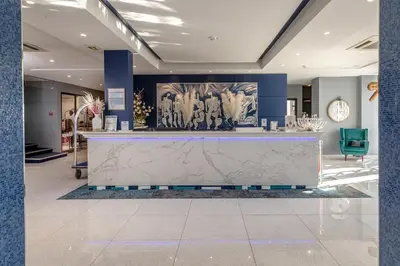 a lobby with a large marble counter in a building at Juliana Hotel Cannes in Cannes