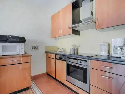 a kitchen with a stove and a microwave at Apartment Reine Astrid-3 by Interhome in Cannes