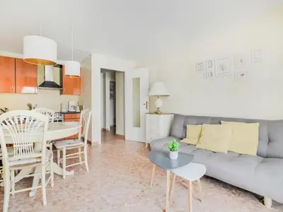 a living room with a couch and a table at Apartment Reine Astrid-3 by Interhome in Cannes