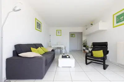 a living room with a couch and a chair at Appartement vacances cannes in Cannes