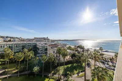 a view of the ocean from the balcony of a resort at Appartements Croisette Grand Hôtel in Cannes