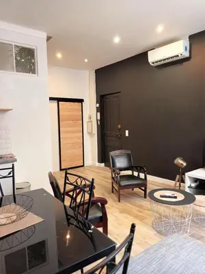 a living room with a black wall and chairs at Centre ville 10 min de la Croisette/Downtown in Cannes