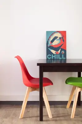 a dining room table with a red chair and a painting at Esperanto in Cannes