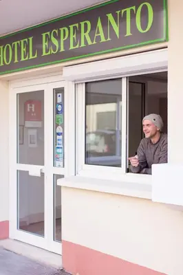 a man looking out of a window of a hotel expedia at Esperanto in Cannes