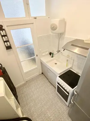 a small kitchen with a stove and a sink at Esperanto in Cannes