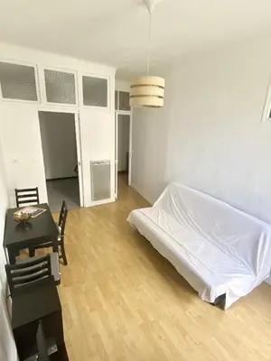 a bedroom with a white bed and a table and a desk at Esperanto in Cannes