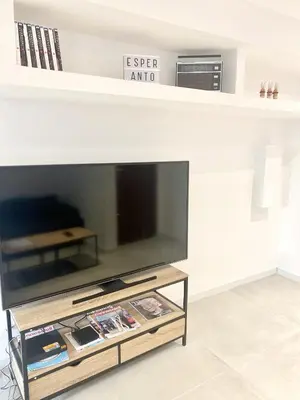 a living room with a tv and a table at Esperanto in Cannes