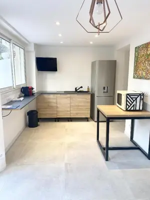 a kitchen with a table and a microwave in it at Esperanto in Cannes