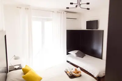 a bedroom with two beds and a large window at Esperanto in Cannes