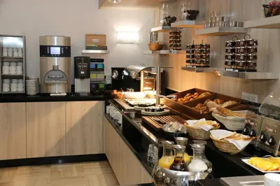 a kitchen with a counter with food on it at GOLDEN TULIP CANNES HOTEL de PARIS in Cannes