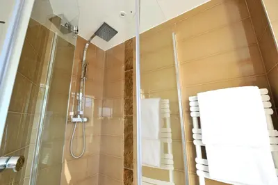 a shower with a glass door in a bathroom at Hôtel La Villa Cannes in Cannes
