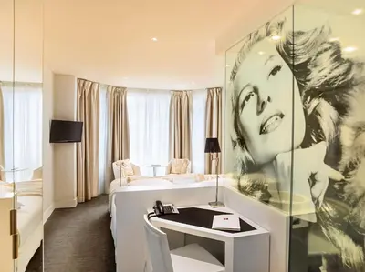 a bathroom with a sink and a mirror at Hotel Renoir in Cannes