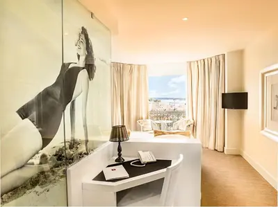 a bathroom with a bath tub and a sink at Hotel Renoir in Cannes