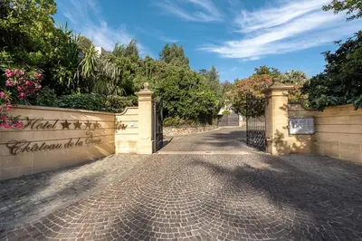 a gate to a house with a driveway at Hôtel Château de la Tour Cannes in Cannes