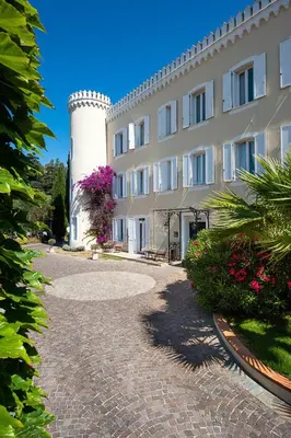 a building with a tower next to a building at Hôtel Château de la Tour Cannes in Cannes