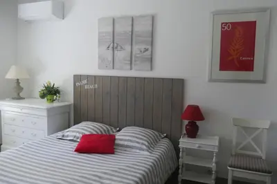 a bedroom with a bed with a red pillow on it at Studio Terrasse in Cannes