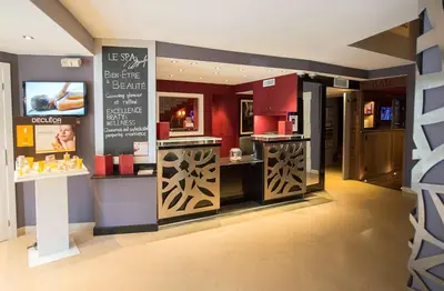 a hotel room with a large bed with avisor at Best Western Plus Cannes Riviera & SPA in Cannes