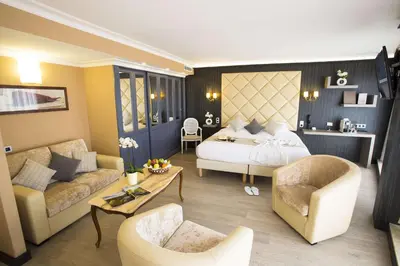 a bedroom with a bed and a living room at Best Western Plus Cannes Riviera & SPA in Cannes